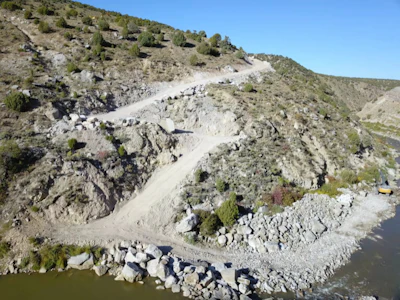 An access road was built (and later restored) down steep terrain to the river. Photo: JHL Constructors