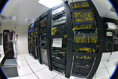 Racks of telecommunications equipment in part of a data center. Photo: Gregory Maxwell