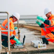Two workers conducting water quality testing. | Photo by iStock
